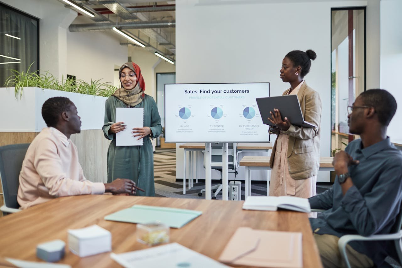 about-bg A diverse team discusses business strategy during an indoor presentation.